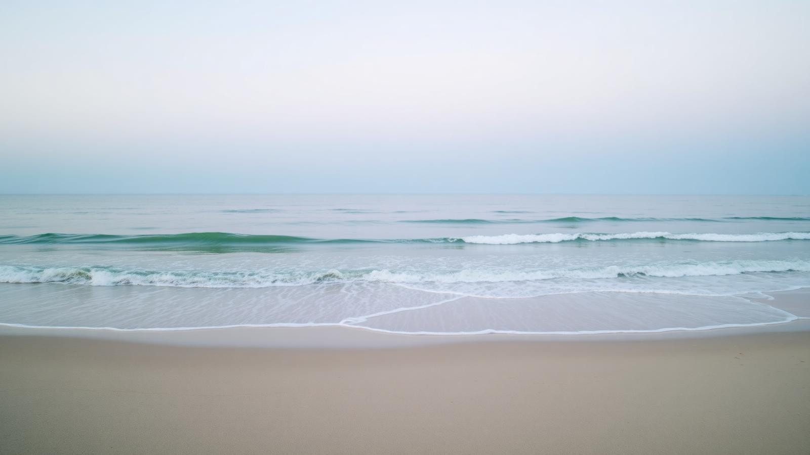Calm waves meeting the shore at dawn